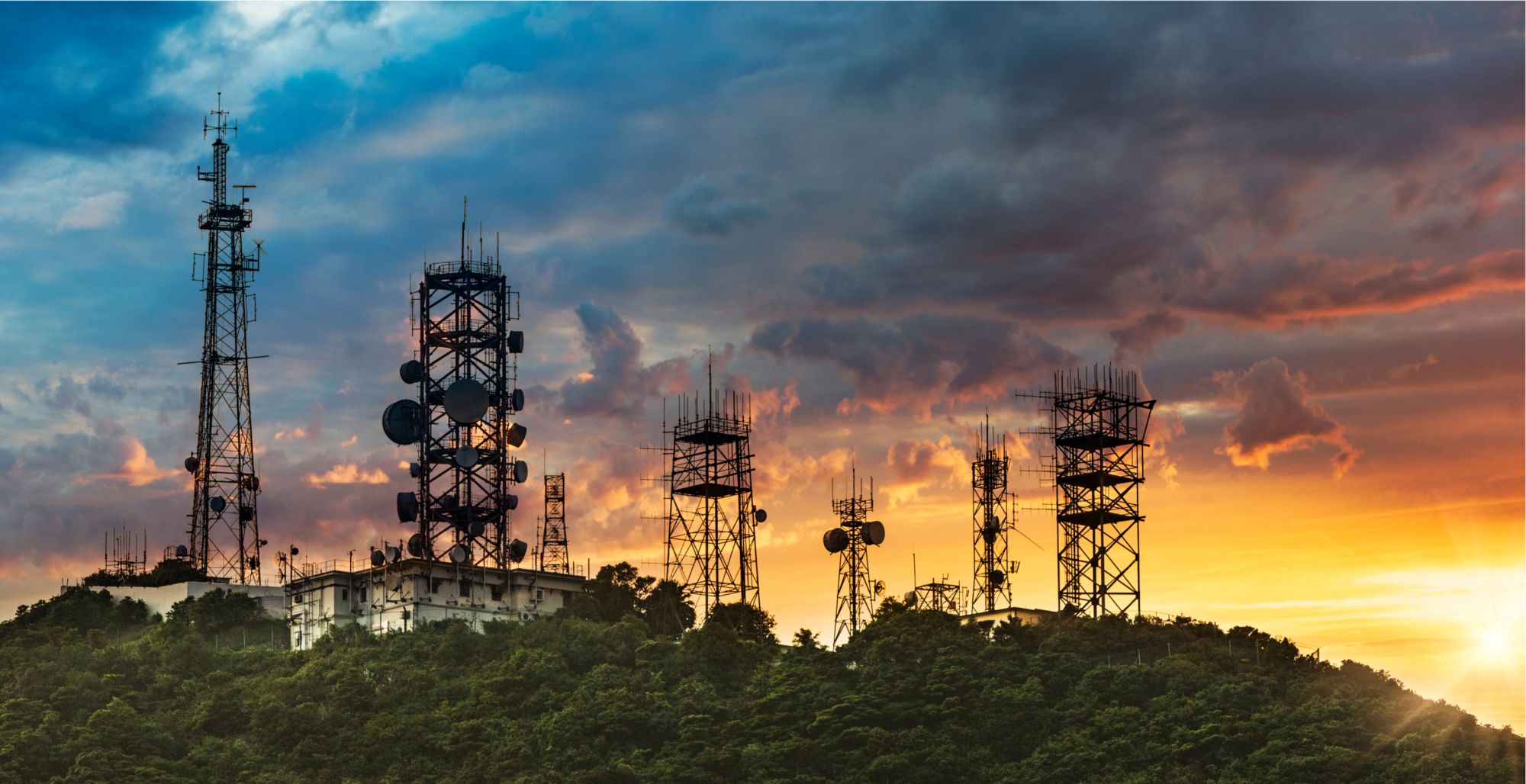 Cell towers standing on a hill.